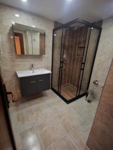 a bathroom with a shower and a sink and a mirror at Hotel Silviya in Istanbul