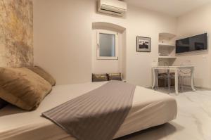 a bedroom with a large bed and a table at Divine Nest in Ljubljana