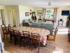 a living room with a table and a couch at Cutteen Cottage in Tulla