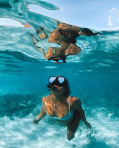 a group of people swimming in the water at Pousada Serra&Mar Angra dos reis in Angra dos Reis