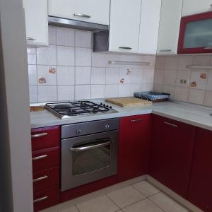 cocina con armarios rojos y fogones en Apartment Ivan, en Split