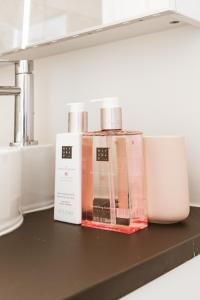 two bottles sitting on a shelf in a kitchen at Luxe studio in Ostend +8 photos