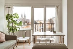 a living room with a table and a large window at Luxe studio in Ostend