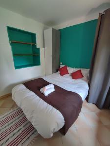 a bedroom with a large white bed with red pillows at Château Saint-Martin in Carcassonne