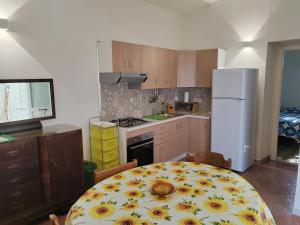 a kitchen with a table with a sunflower plate on it at Villaglauca in Maratea