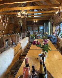 a large wooden table in a living room with bottles at Montagnoli Luxury Villa in Cluj-Napoca