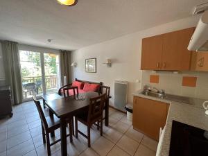 a kitchen and dining room with a table and chairs at Le Green in Levernois