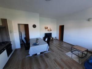 a living room with a table and some chairs at MaroVito in Supetarska Draga