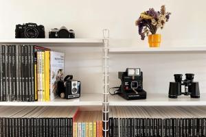 a shelf with cameras and other items on it at Charm Authentic Family Stay in Lisbon
