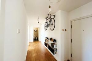 a bike hanging on a wall in a hallway at Charm Authentic Family Stay in Lisbon