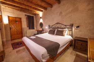 a bedroom with a large bed in a room at Canyon Cave Hotel in Urgup