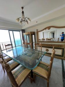 a dining room with a glass table and chairs at شقه فاخره - ابراج سان ستيفانو- جراند بلاز in Alexandria