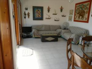 - un salon avec un canapé et une table dans l'établissement Porto Azzuro Apartment 6 Beds, à Porto Azzurro