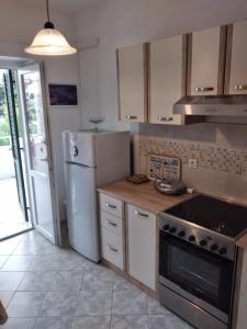 a kitchen with a refrigerator and a stove at Apartment and rooms Hvar Limoni accessible today in Hvar