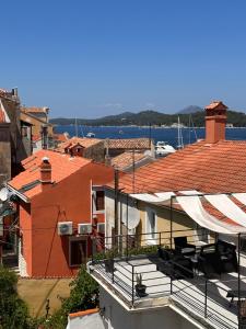 a view of a balcony of a building with a view of the water at UNA apartment in center of Mali Lošinj in Mali Lošinj