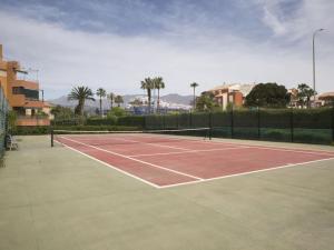 a tennis court with a net on top of it at Jardines del Mar Salobreña in Salobreña