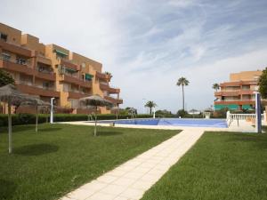 a resort with a swimming pool and a building at Jardines del Mar Salobreña in Salobreña