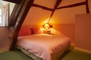 מיטה או מיטות בחדר ב-La maison d'Hector