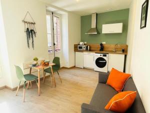 a living room with a couch and a table at L’échappée verte in Caussade +19 photos