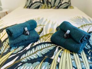 two towels sitting on top of a bed at L’échappée verte in Caussade