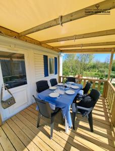 a table on the deck of a house at Camping Sainte Mère Eglise in Sainte-Mère-Église