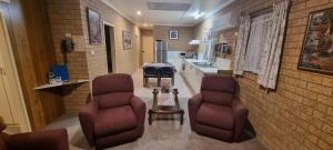 Pokój z 2 krzesłami i kuchnią w obiekcie Lone Pine Motel w mieście Corowa