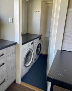 a laundry room with a washing machine in it at Centralt belägen villa i Öjebyn, Piteå in Piteå