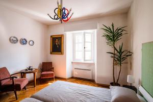 ein Schlafzimmer mit einem Bett und einer Topfpflanze in der Unterkunft Art House Radovljica in Radovljica