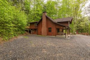 a log cabin in the middle of a forest at Creekside Hideaway in Reedsville