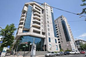 a tall building with cars parked in front of it at Teryan street, 3 bedrooms Luxury & Grand, Sunny apartment TT663 in Yerevan