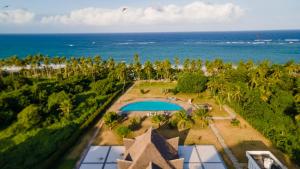 an aerial view of a resort with a swimming pool and the ocean at Beachside Bliss Studio in Ukunda
