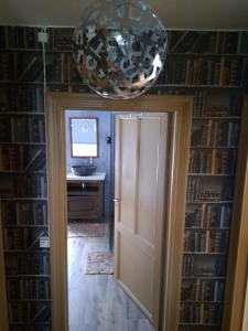 a door leading to a room with a desk and a television at Aux alouettes in Landelies