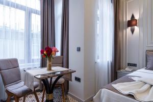 a hotel room with a bed and a table with flowers on it at Pera Luna Premium Hotel in Istanbul