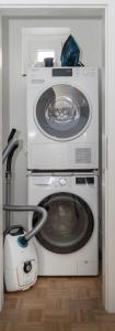 eine Waschmaschine in einem Raum mit Staubsauger in der Unterkunft Comfort Apart Baden-Baden in Baden-Baden