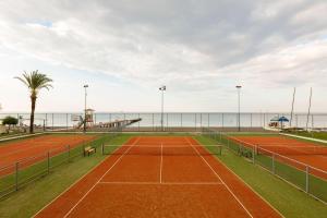 a tennis court with the ocean in the background at Labranda Alantur in Alanya