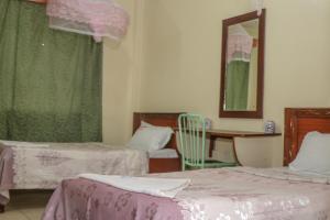 Postel nebo postele na pokoji v ubytování KAP Guest House