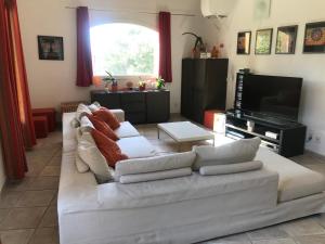 un soggiorno con divano bianco e TV di Solio a Meyrargues
