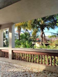 a balcony with a view of a palm tree at Ladakh House- 3 BHK Ladakh themed Villa near Matheran in Neral
