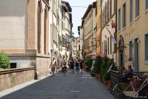 a group of people walking down a street with buildings at Alessandra Apartment in Lucca