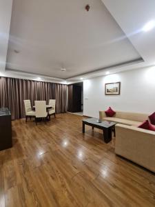 a living room with a couch and a table at Hotel Central Palace in Dehradun