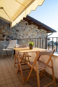 a wooden table and chairs on a balcony at Poggio Valeria, relax in Toscana in Saturnia