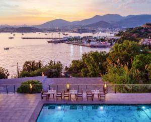 a resort with a pool and a view of the water at Senses Hotel - Adults Only in Bodrum City