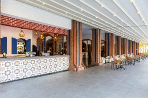a restaurant with a bar with tables and chairs at Kairaba Bodrum Imperial in Akyarlar