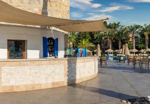 a resort with a patio with tables and umbrellas at Selectum Collection Bodrum in Akyarlar