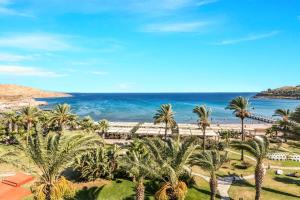 a view of a beach with palm trees and the ocean at Selectum Collection Bodrum in Akyarlar
