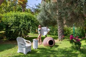 a woman standing on a large barrel in a yard at Selectum Collection Bodrum in Akyarlar