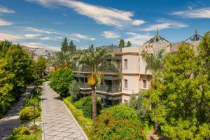 an apartment building with a walkway and trees at Selectum Collection Bodrum in Akyarlar