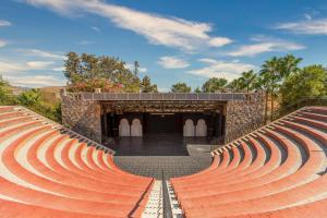 an amphitheater with red brick seats in front of a building at Selectum Collection Bodrum in Akyarlar