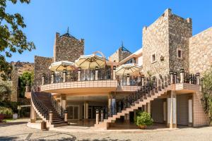 a large stone building with stairs and a balcony at Selectum Collection Bodrum in Akyarlar