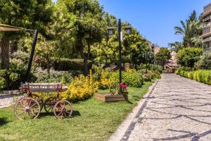 a park with a horse drawn carriage on the grass at Selectum Collection Bodrum in Akyarlar